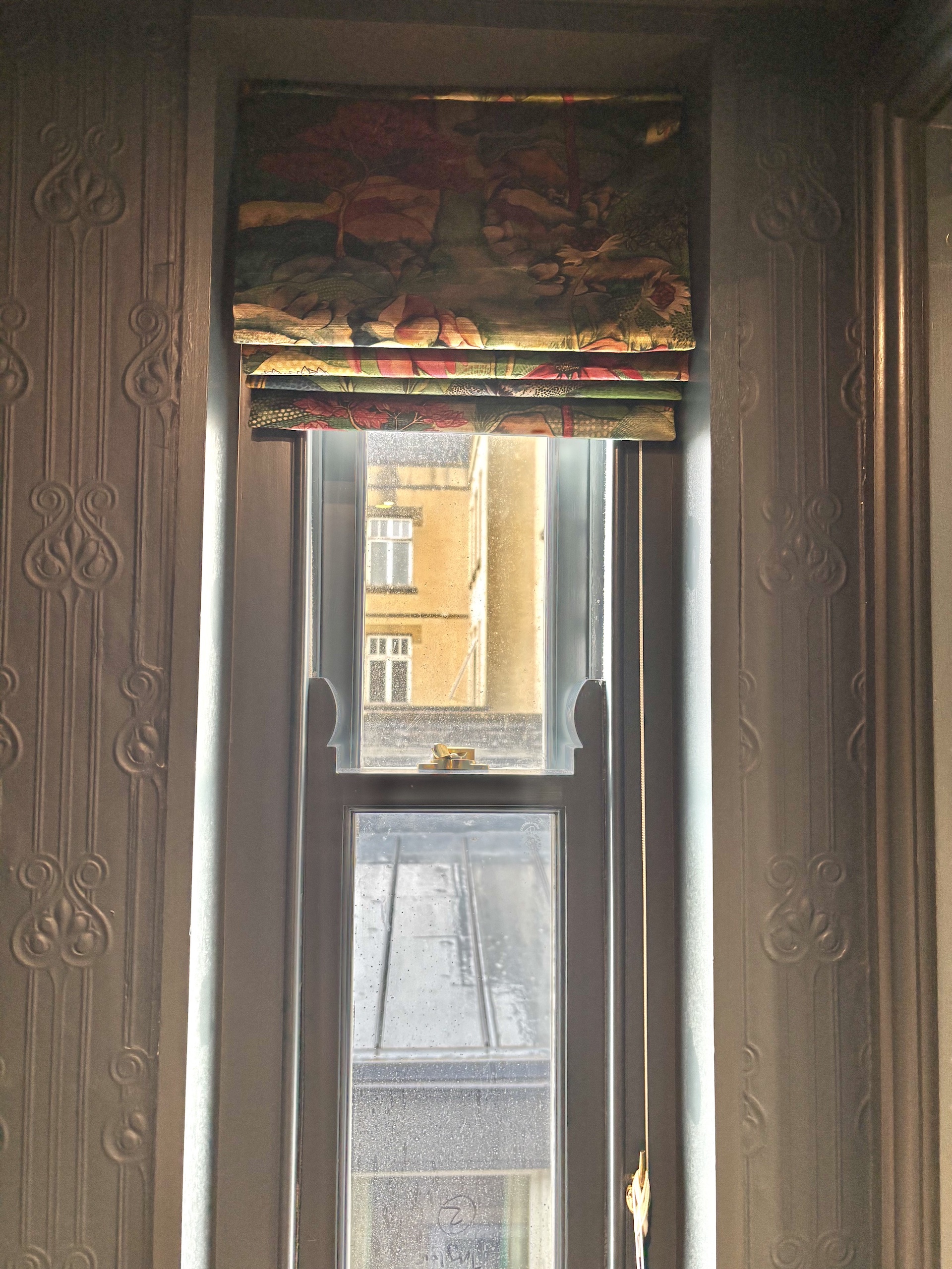 Narrow window with patterned bespoke blind. Work by Fiona Lawson Design