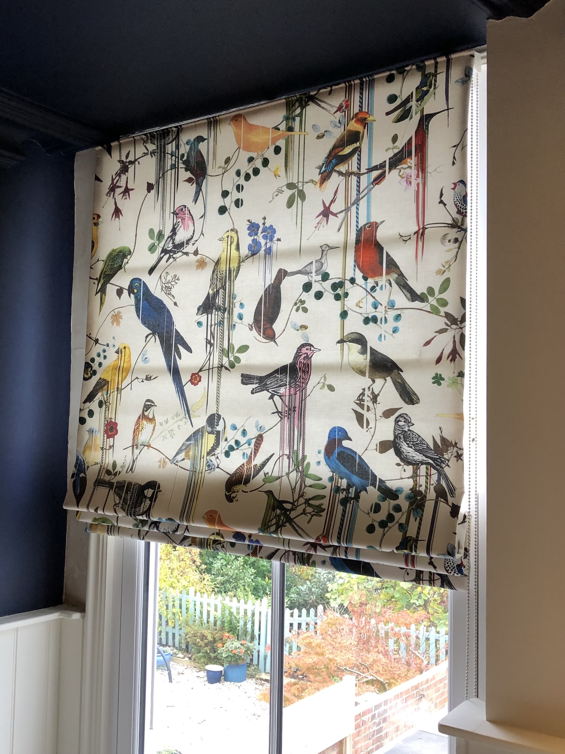 Custom blind with bird fabric. Work by Fiona Lawson Design.